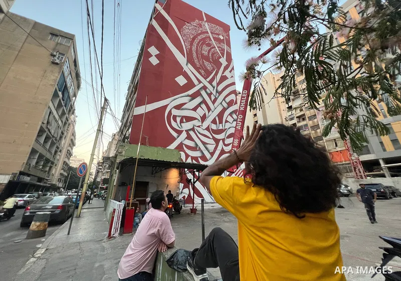 Palestinian artist Bilal Khaled draws on a wall a graffiti mural in Beirut on June 19, 2022. Photo by Nidal Al-Wahidi