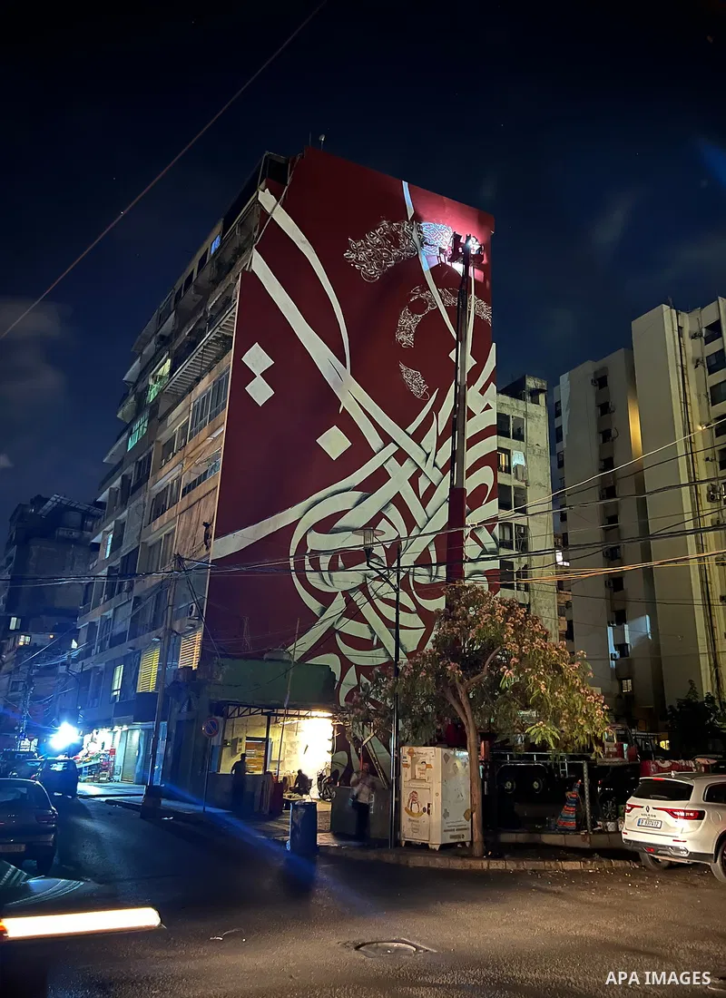 Palestinian artist Bilal Khaled draws on a wall a graffiti mural in Beirut on June 19, 2022. Photo by Nidal Al-Wahidi