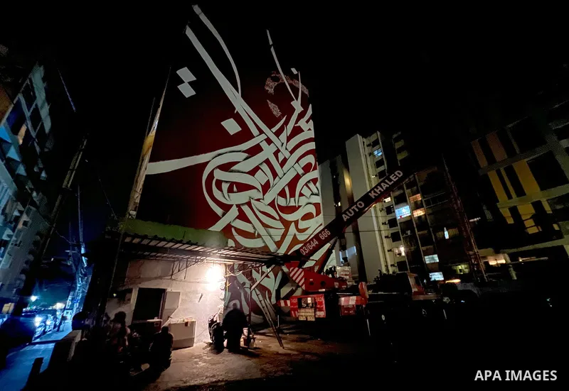 Palestinian artist Bilal Khaled draws on a wall a graffiti mural in Beirut on June 19, 2022. Photo by Nidal Al-Wahidi