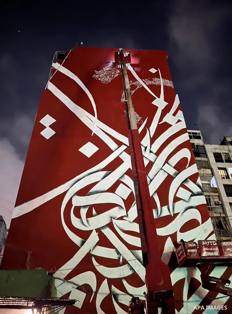 Palestinian artist Bilal Khaled draws on a wall a graffiti mural in Beirut on June 19, 2022. Photo by Nidal Al-Wahidi