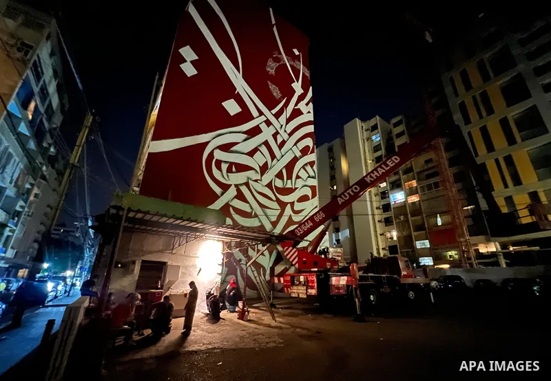 Palestinian artist Bilal Khaled draws on a wall a graffiti mural in Beirut on June 19, 2022. Photo by Nidal Al-Wahidi