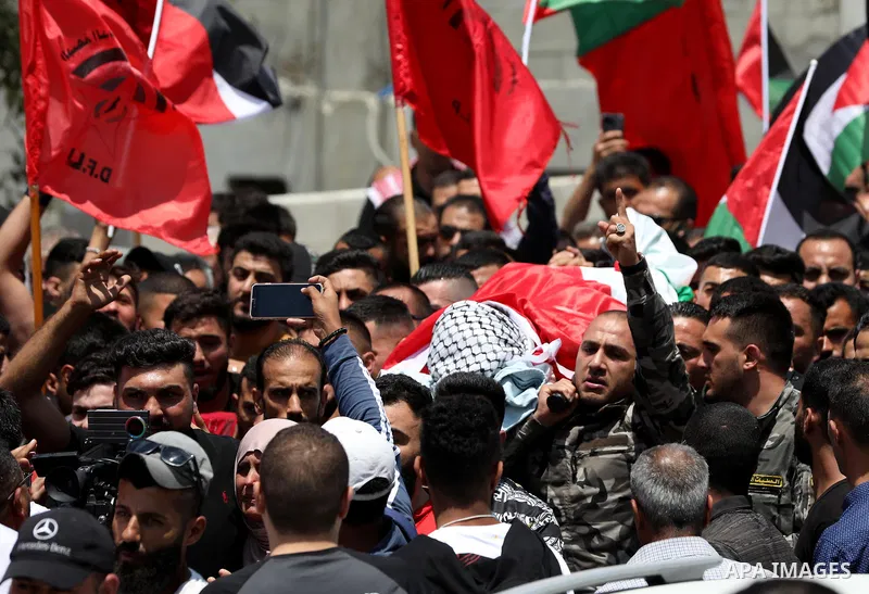 Mourners attend the funeral of Palestinian Ali Harb, who was killed by an Israeli settler in the northern West Bank village of Iskaka, on June 22, 2022. An Israeli settler stabbed a Palestinian to death in the West Bank...