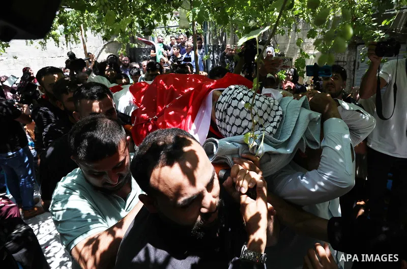 Mourners attend the funeral of Palestinian Ali Harb, who was killed by an Israeli settler in the northern West Bank village of Iskaka, on June 22, 2022. An Israeli settler stabbed a Palestinian to death in the West Bank...