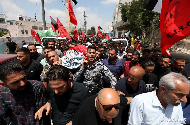 Mourners attend the funeral of Palestinian Ali Harb, who was killed by an Israeli settler in the northern West Bank village of Iskaka, on June 22, 2022. An Israeli settler stabbed a Palestinian to death in the West Bank...