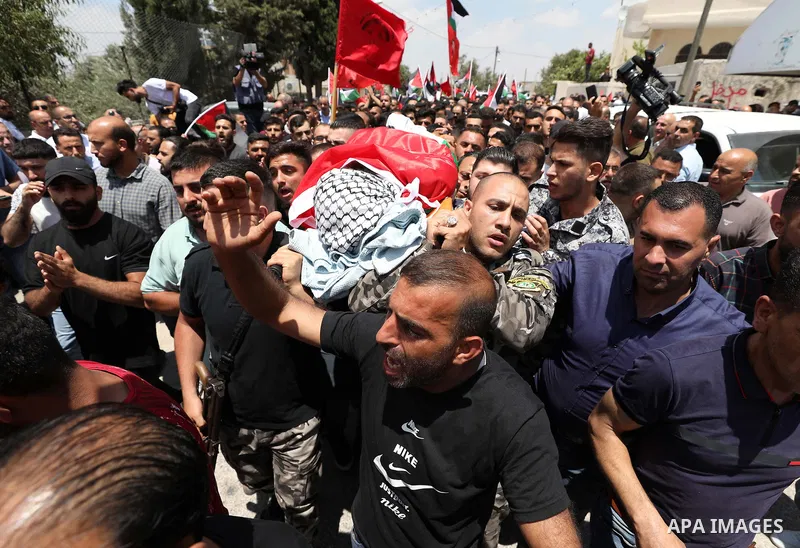 Mourners attend the funeral of Palestinian Ali Harb, who was killed by an Israeli settler in the northern West Bank village of Iskaka, on June 22, 2022. An Israeli settler stabbed a Palestinian to death in the West Bank...