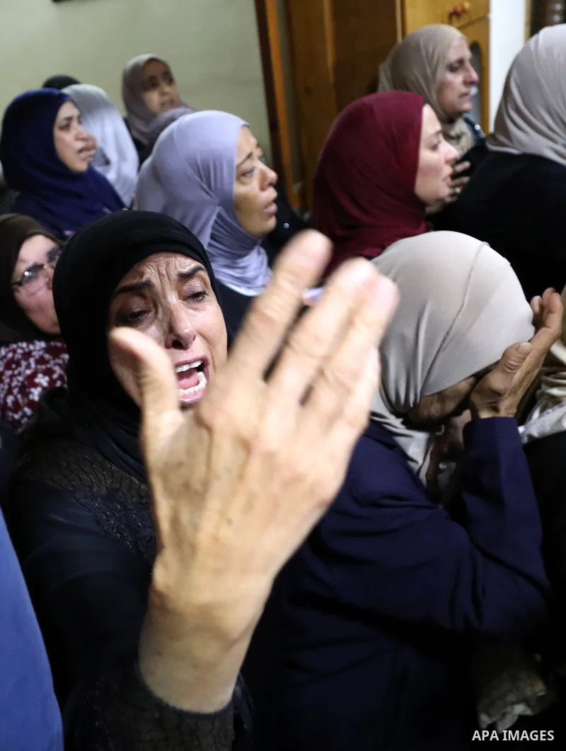 Mourners attend the funeral of Palestinian Ali Harb, who was killed by an Israeli settler in the northern West Bank village of Iskaka, on June 22, 2022. An Israeli settler stabbed a Palestinian to death in the West Bank...