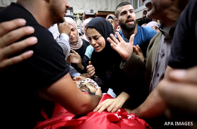 Mourners attend the funeral of Palestinian Ali Harb, who was killed by an Israeli settler in the northern West Bank village of Iskaka, on June 22, 2022. An Israeli settler stabbed a Palestinian to death in the West Bank...