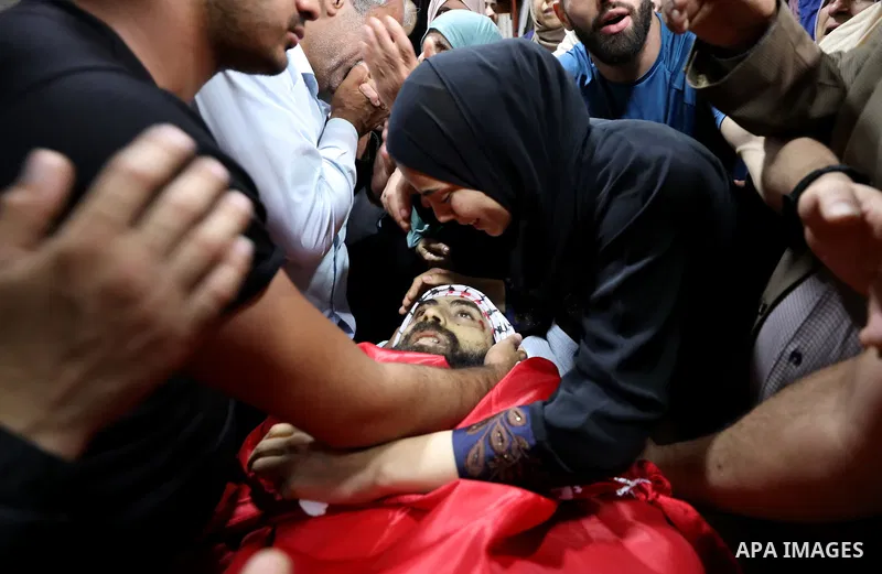 Mourners attend the funeral of Palestinian Ali Harb, who was killed by an Israeli settler in the northern West Bank village of Iskaka, on June 22, 2022. An Israeli settler stabbed a Palestinian to death in the West Bank...