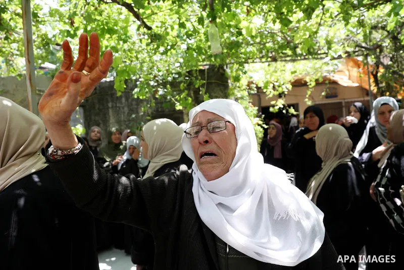 Mourners attend the funeral of Palestinian Ali Harb, who was killed by an Israeli settler in the northern West Bank village of Iskaka, on June 22, 2022. An Israeli settler stabbed a Palestinian to death in the West Bank...