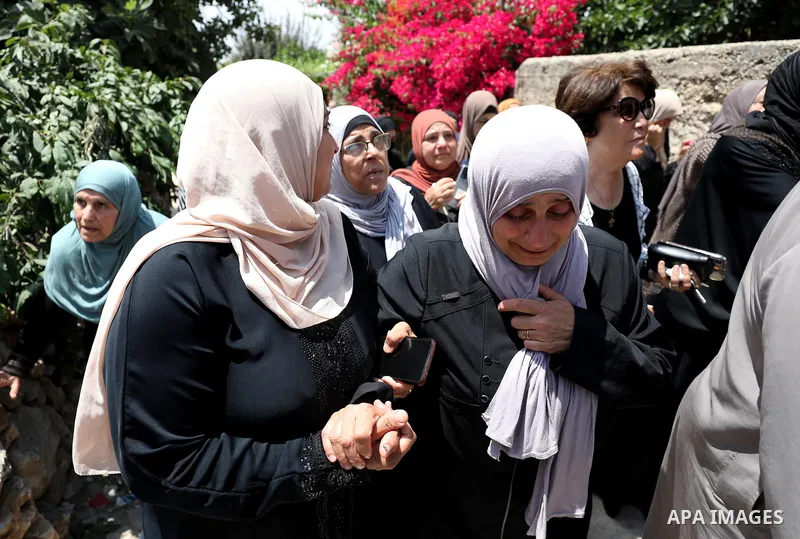 Mourners attend the funeral of Palestinian Ali Harb, who was killed by an Israeli settler in the northern West Bank village of Iskaka, on June 22, 2022. An Israeli settler stabbed a Palestinian to death in the West Bank...