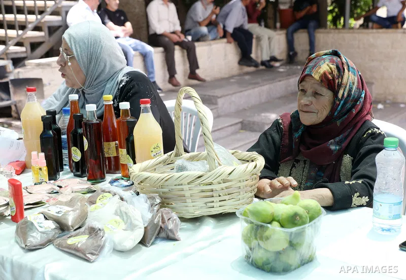 Palestinians attend the farmers market in the West Bank city of Ramallah, on June 25, 2022. Photo by Wajed Nobani
