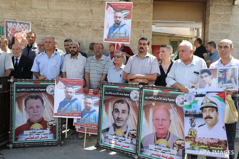 Palestinians take part in a protest to show solidarity with prisoners on hunger strike held in Israeli jails, in front of Red cross office in Gaza city, on June 27, 2022. Amnesty International, has described Israel's adm...