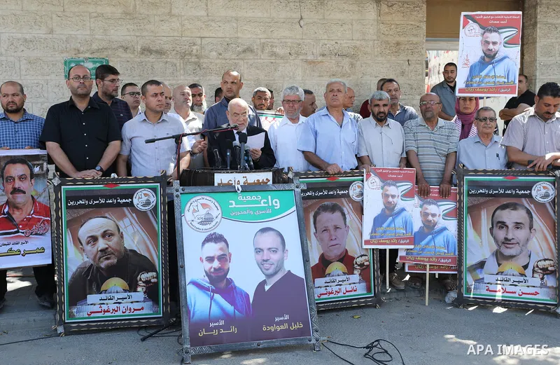 Palestinians take part in a protest to show solidarity with prisoners on hunger strike held in Israeli jails, in front of Red cross office in Gaza city, on June 27, 2022. Amnesty International, has described Israel's adm...
