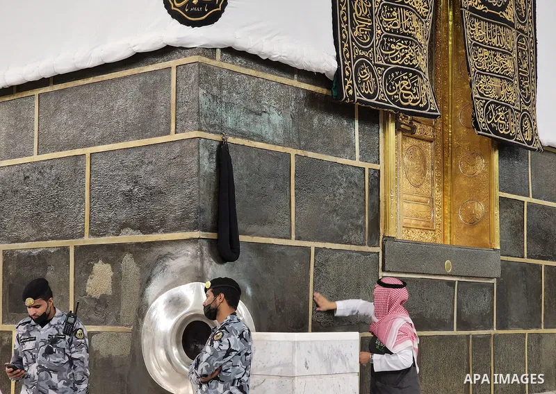 Saudi security men stand guard around the "Black Stone", set into the eastern corner of the Kaaba, at the Grand Mosque complex in the Saudi holy city of Mecca, during annual Hajj pilgrimage on June 27, 2022. Annual Saudi...