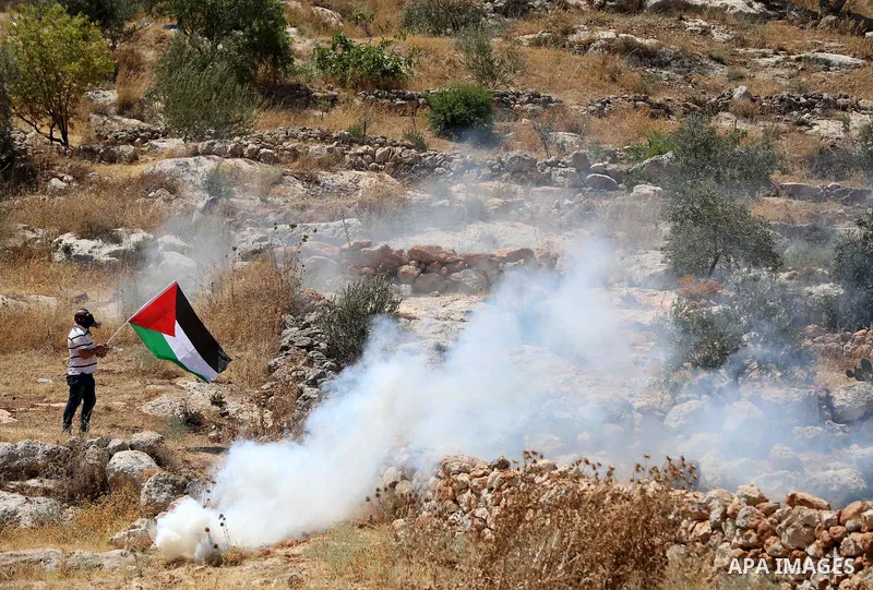 Palestinian protesters clash with Israeli forces during a demonstration against settlements in the village of Beit Dajan in the West Bank on July 8, 2022. Photo by Wajed Nobani