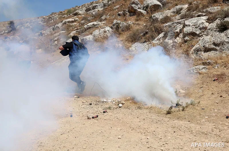 Palestinian protesters clash with Israeli forces during a demonstration against settlements in the village of Beit Dajan in the West Bank on July 8, 2022. Photo by Wajed Nobani