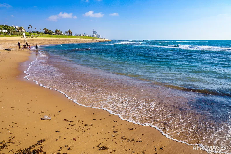 people enjoy the beach of the Mediterranean sea in Jaffa, on July 14, 2022. Old Jaffa is located in the northwest of Jaffa, on a hill along the Mediterranean Sea. Geologically, the hill of Old Jaffa is the continental no...