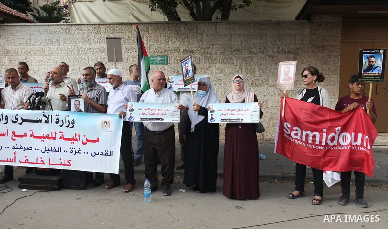 Palestinians take part in a protest in solidarity with the prisoners on hunger strike in front of the headquarters of the Red Cross in Gaza City on 23 July 2022. Some 75 Palestinian freedom fighters incarcerated in Israe...