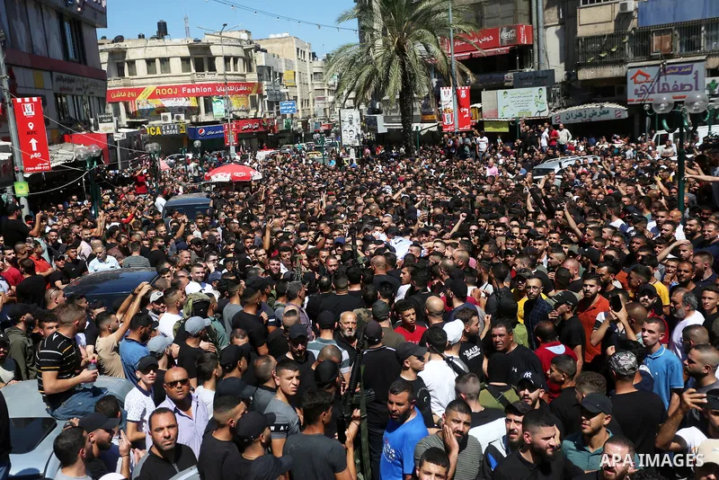 Mourners carry the bodies of two Palestinians who were killed by Israeli forces, during their funeral, in the West Bank city of Nablus on July 24, 2022. Two Palestinians were shot dead last night and ten others wounded,...