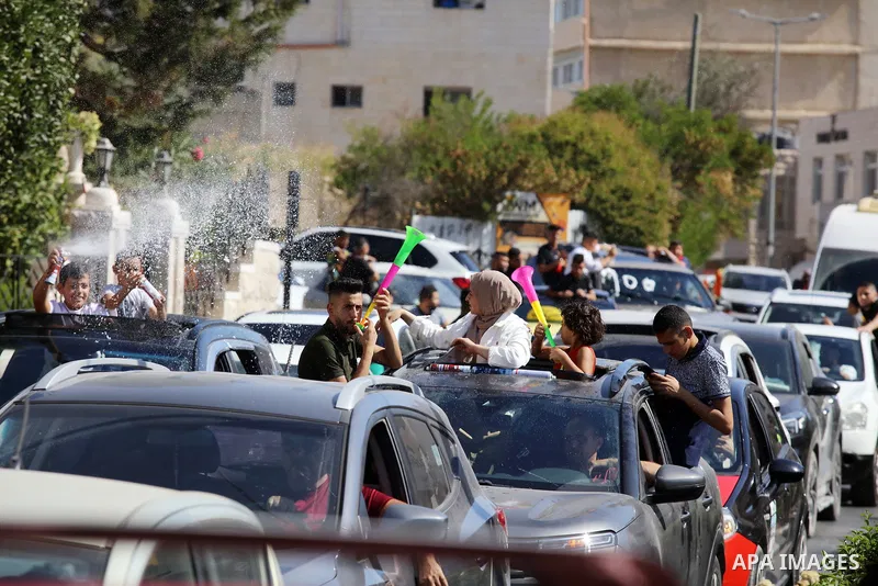 Palestinian high school students celebrate at streets after results the final exams known as "Tawjihi", in the West bank city of Bethlehem on July 30, 2022. Photo by Ahmad Tayem