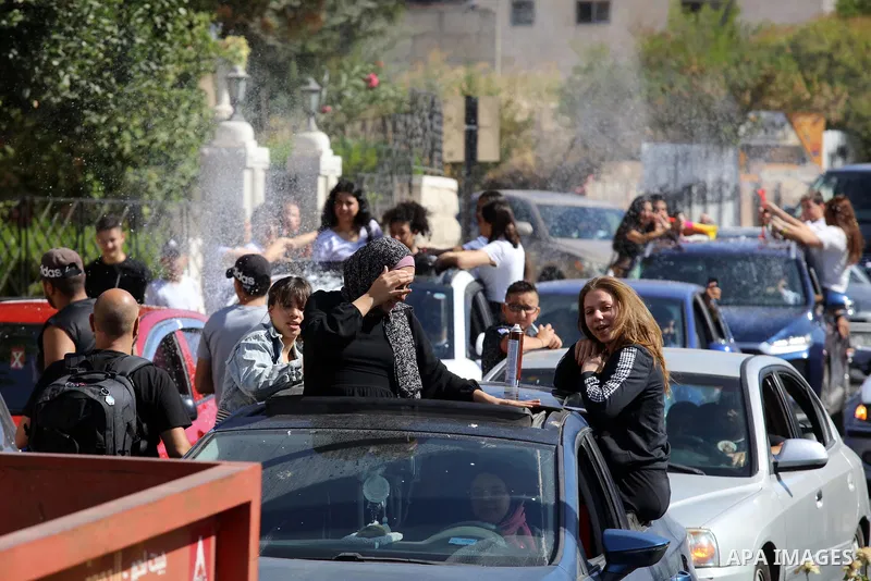 Palestinian high school students celebrate at streets after results the final exams known as "Tawjihi", in the West bank city of Bethlehem on July 30, 2022. Photo by Ahmad Tayem