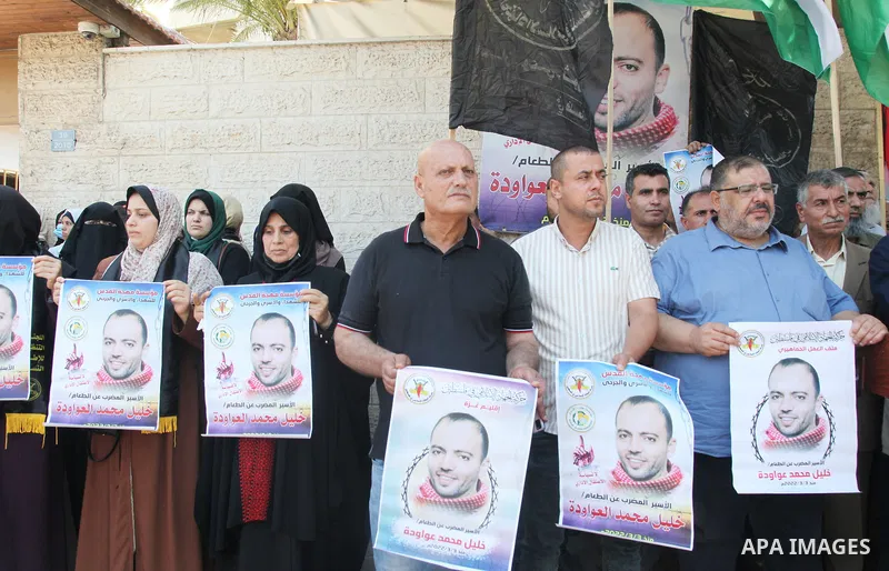 Palestinian supporters of the Islamic Jihad Movement take part in a protest in solidarity with Khalil Awawdeh, 40, has been on hunger strike in front of the headquarters of the Red Cross in Gaza City, on on August 1, 202...
