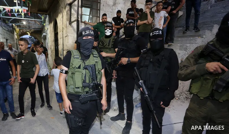 Palestinian militants from the Al-Aqsa Martyrs Brigades, the military wing of the Fatah movement, participate in the ceremony for the prisoner Abd al-Salam Shabaro, upon his release from Israeli jails, in the West Bank c...