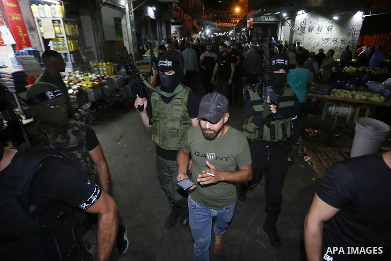 Palestinian militants from the Al-Aqsa Martyrs Brigades, the military wing of the Fatah movement, participate in the ceremony for the prisoner Abd al-Salam Shabaro, upon his release from Israeli jails, in the West Bank c...