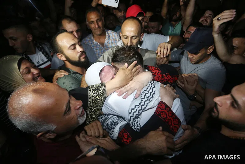 Palestinian militants from the Al-Aqsa Martyrs Brigades, the military wing of the Fatah movement, participate in the ceremony for the prisoner Abd al-Salam Shabaro, upon his release from Israeli jails, in the West Bank c...