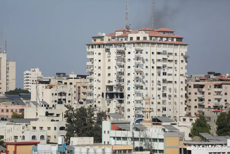 Smoke rises from a building following an Israeli air strike on Gaza City on August 5, 2022. The Israeli military said today it launched air strikes on Gaza, which were witnessed by Palestinians in central Gaza City. Phot...