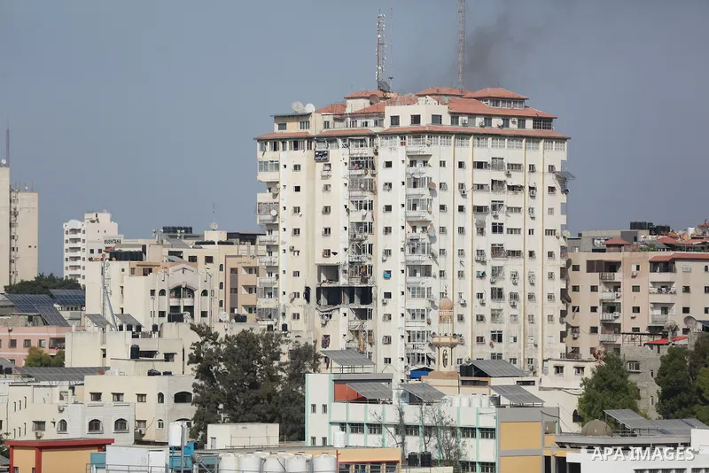 Smoke rises from a building following an Israeli air strike on Gaza City on August 5, 2022. The Israeli military said today it launched air strikes on Gaza, which were witnessed by Palestinians in central Gaza City. Phot...