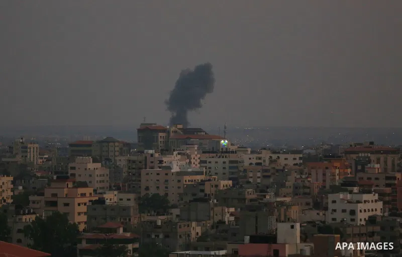 Smoke rises from a building following an Israeli air strike on Gaza City on August 5, 2022. The Israeli military said today it launched air strikes on Gaza, which were witnessed by Palestinians in central Gaza City. Phot...