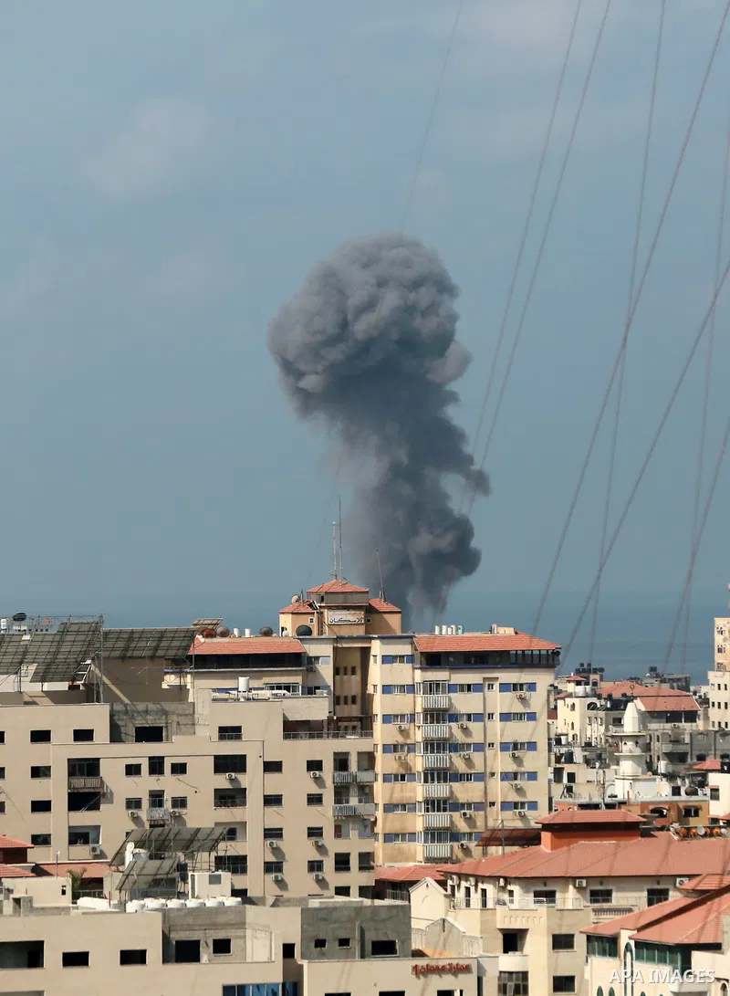 Smoke rises from a building following an Israeli air strike on Gaza City on August 6, 2022. Photo by Bashar Taleb