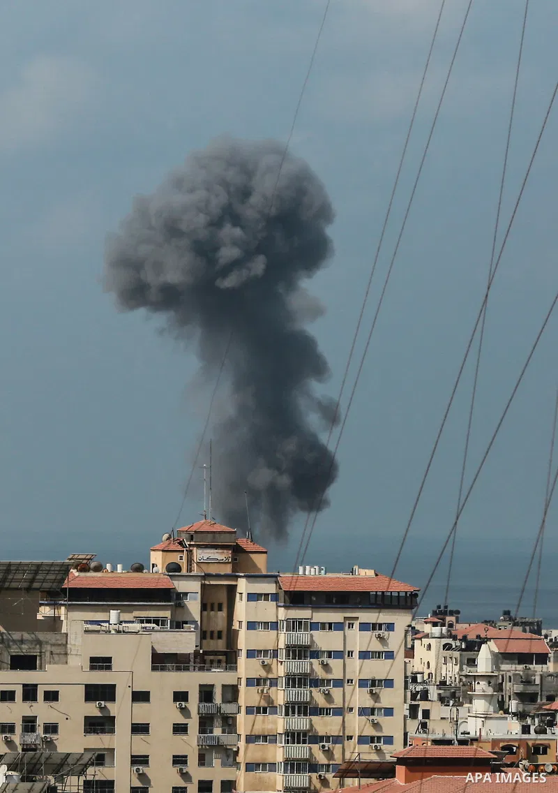 Smoke rises from a building following an Israeli air strike on Gaza City on August 6, 2022. Photo by Bashar Taleb