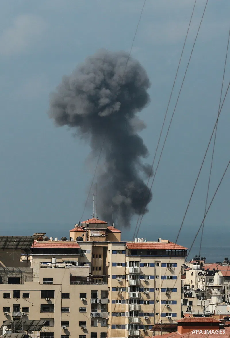 Smoke rises from a building following an Israeli air strike on Gaza City on August 6, 2022. Photo by Bashar Taleb