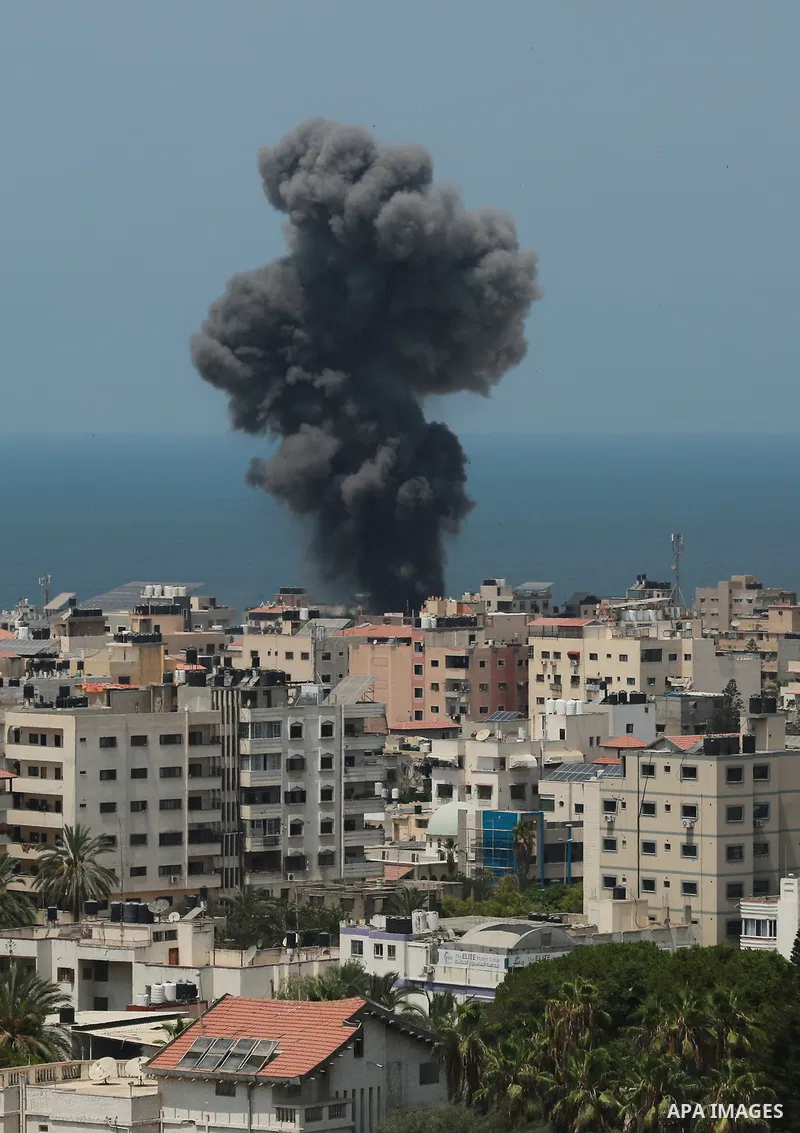Smoke rises from a building following an Israeli air strike on Gaza City on August 6, 2022. Israel attacked the besieged Gaza Strip with warplanes on Friday, killing at least 11 people including a commander of the Islami...