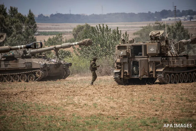 A soldier of Israel Defence Forces (IDF) stands next to artillery batteries at the Israeli Gaza border near Sderot 06 August 2022, Israel. The Israel Defence Forces said on Saturday they are preparing for a ''week of ope...