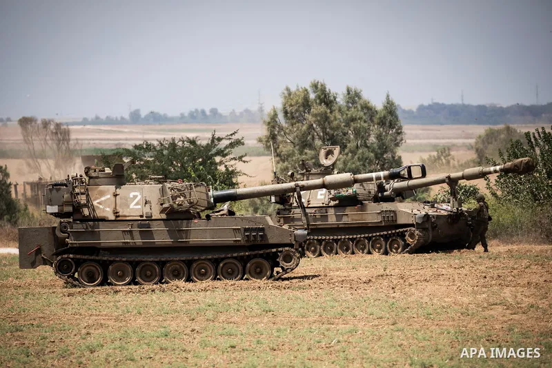 A soldier of Israel Defence Forces (IDF) stands next to artillery batteries at the Israeli Gaza border near Sderot 06 August 2022, Israel. The Israel Defence Forces said on Saturday they are preparing for a ''week of ope...
