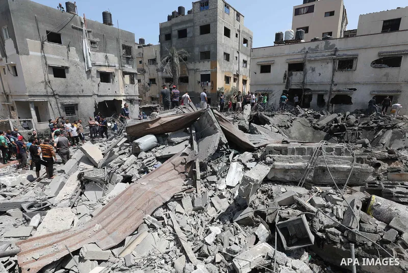 Palestinians inspect the rubble of a building following an Israeli air strike in Gaza City on August 6, 2022. Israel attacked the besieged Gaza Strip with warplanes on Friday, killing at least 11 people including a comma...