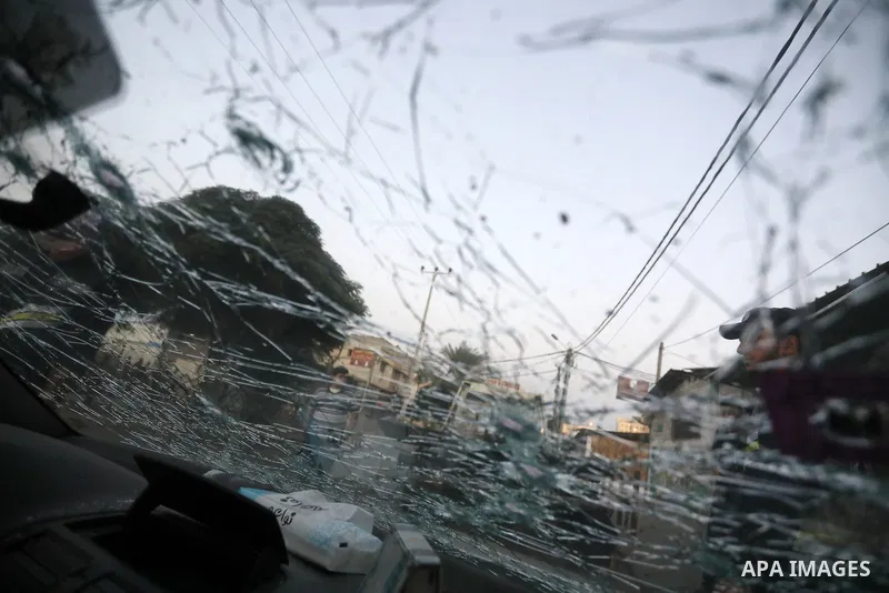 Palestinians inspect a car following an Israeli air strike in Gaza city on August 7, 2022. Latest figures by the Ministry of Health show that the number of Palestinians killed since the beginning of the Israeli aggressio...