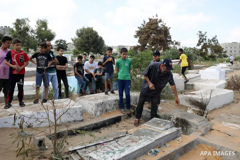 Palestinian children inspect a cemetery where Palestinians from Najam family including children were killed on Sunday by an Israeli air strike in Jabalia in the northern of Gaza strip on August 8, 2022. The cease-fire en...