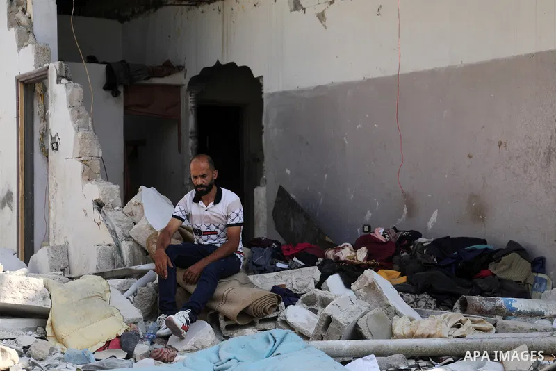 Palestinians look out of a heavily damaged building in Jabalia in the northern of Gaza strip on August 8, 2022. The cease-fire ended more than two days of intense cross-border violence that started Friday, when Israel ki...