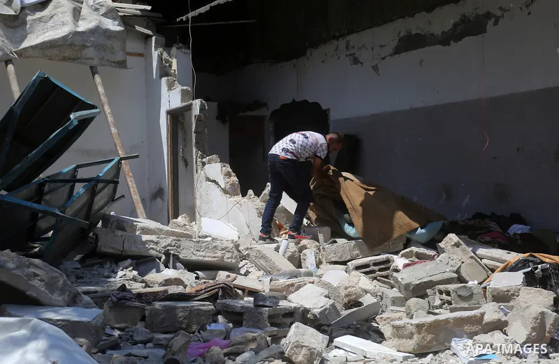 Palestinians from Abu Jasser family, inspect the rubbles of their house which was hit by an Israeli air strike in Jabalia in the northern of Gaza strip on August 8, 2022. The cease-fire ended more than two days of intens...