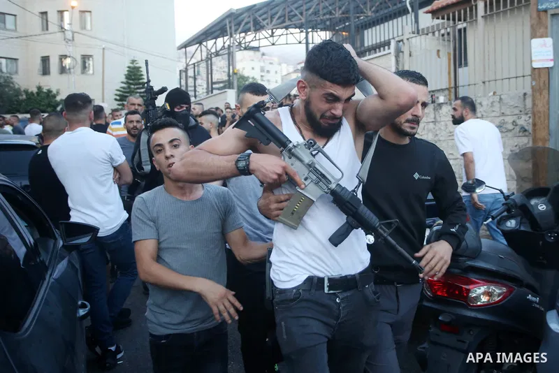 (FILE) A photo shows Palestinian commander of the Al-Aqsa Martyrs' Brigade Ibrahim al-Nabulsi holds his weapon at street in the West Bank city of Nablus. Al-Nabulsi killed today August 9, 2022 in an Israeli raid in the W...