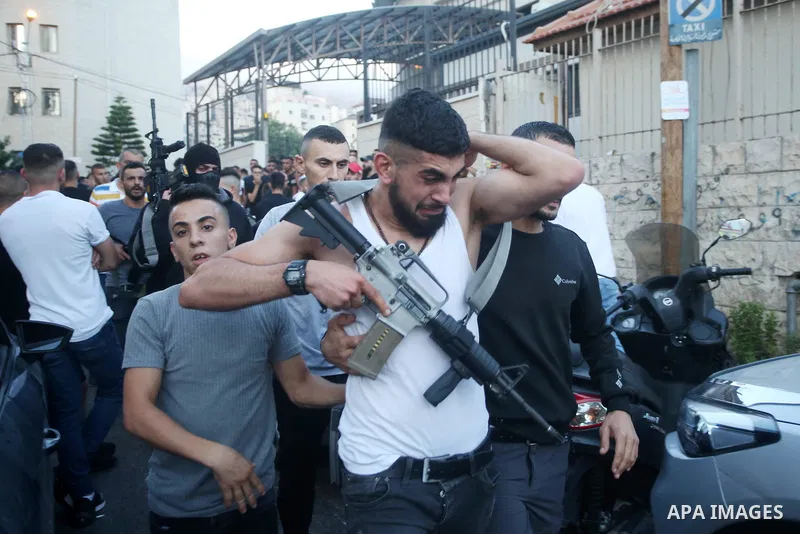 (FILE) A photo shows Palestinian commander of the Al-Aqsa Martyrs' Brigade Ibrahim al-Nabulsi holds his weapon at street in the West Bank city of Nablus. Al-Nabulsi killed today August 9, 2022 in an Israeli raid in the W...