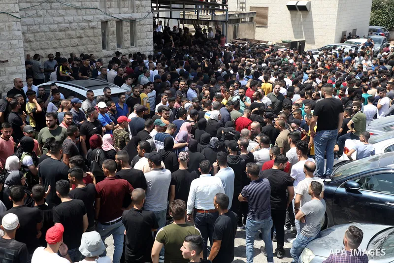 Mourners attend the funeral of Palestinian commander of the Al-Aqsa Martyrs' Brigade Ibrahim al-Nabulsi along with two of his comrades, who was killed in an Israeli raid, in the West Bank city of Nablus on August 9, 2022...
