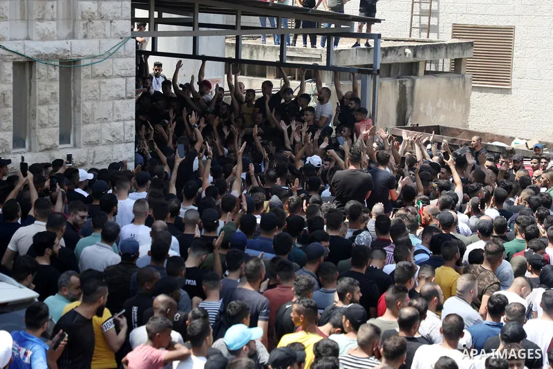 Mourners attend the funeral of Palestinian commander of the Al-Aqsa Martyrs' Brigade Ibrahim al-Nabulsi along with two of his comrades, who was killed in an Israeli raid, in the West Bank city of Nablus on August 9, 2022...
