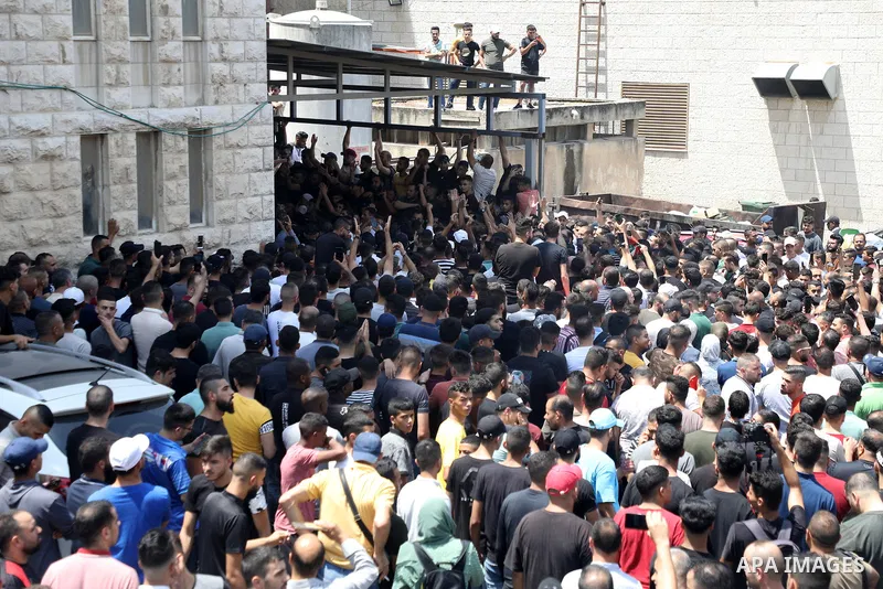 Mourners attend the funeral of Palestinian commander of the Al-Aqsa Martyrs' Brigade Ibrahim al-Nabulsi along with two of his comrades, who was killed in an Israeli raid, in the West Bank city of Nablus on August 9, 2022...