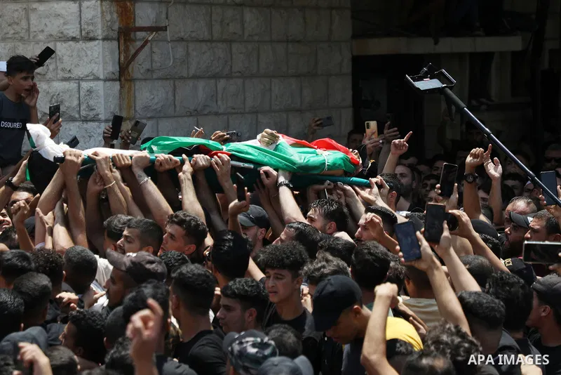 Mourners carry the bodies of Palestinian commander of the Al-Aqsa Martyrs' Brigade Ibrahim al-Nabulsi along with two of his comrades, who were killed in an Israeli raid, during a funeral procession in the West Bank city...