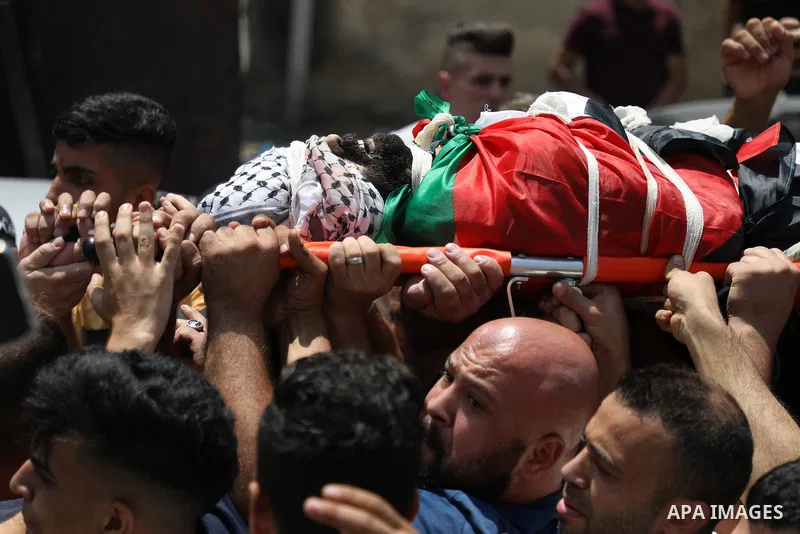 Mourners carry the bodies of Palestinian commander of the Al-Aqsa Martyrs' Brigade Ibrahim al-Nabulsi along with two of his comrades, who were killed in an Israeli raid, during a funeral procession in the West Bank city...